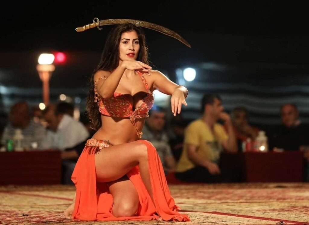 "Experience the exotic art of belly dancing during your Evening Desert Safari in Dubai.