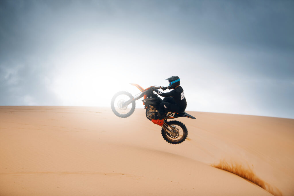 Rider,On,A,Cross-country,Motorcycle,Jump,At,The,Desert.,Dirt