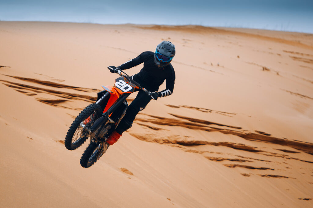 Motorcyclist,On,A,Cross-country,Motorcycle,Jump,From,The,Sand,Dune