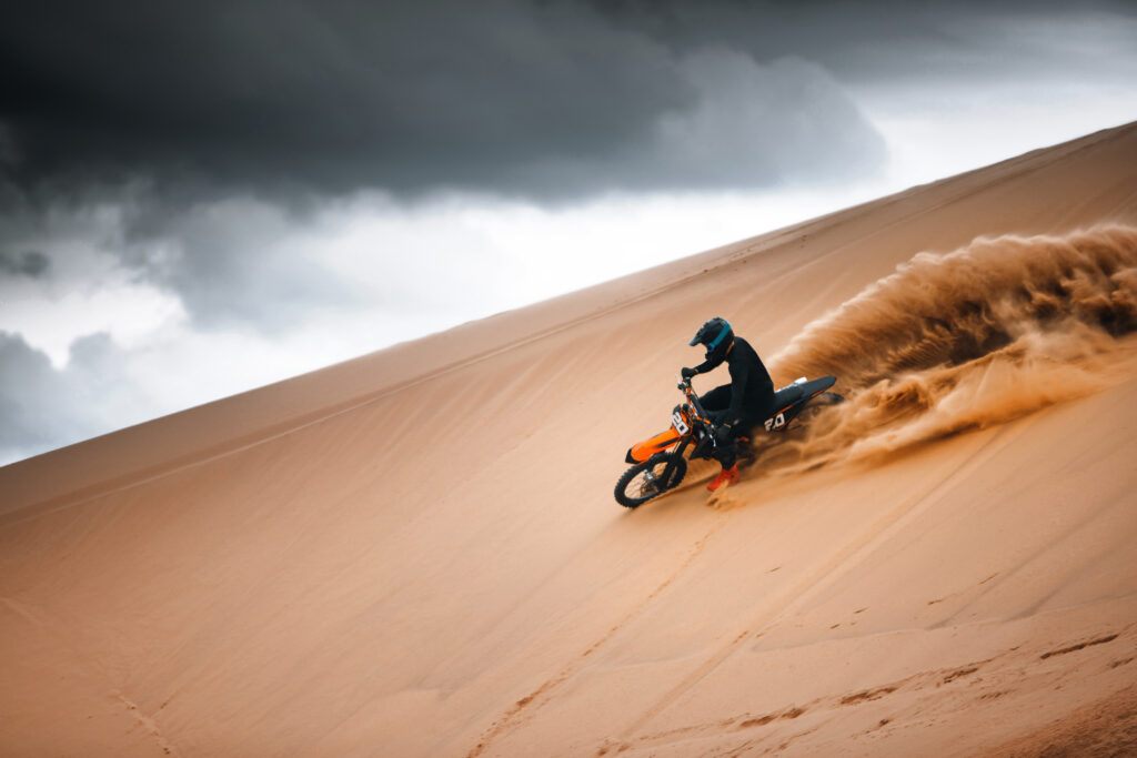 Motorcyclist,On,A,Cross-country,Motorcycle,Go,Fast,At,The,Desert
